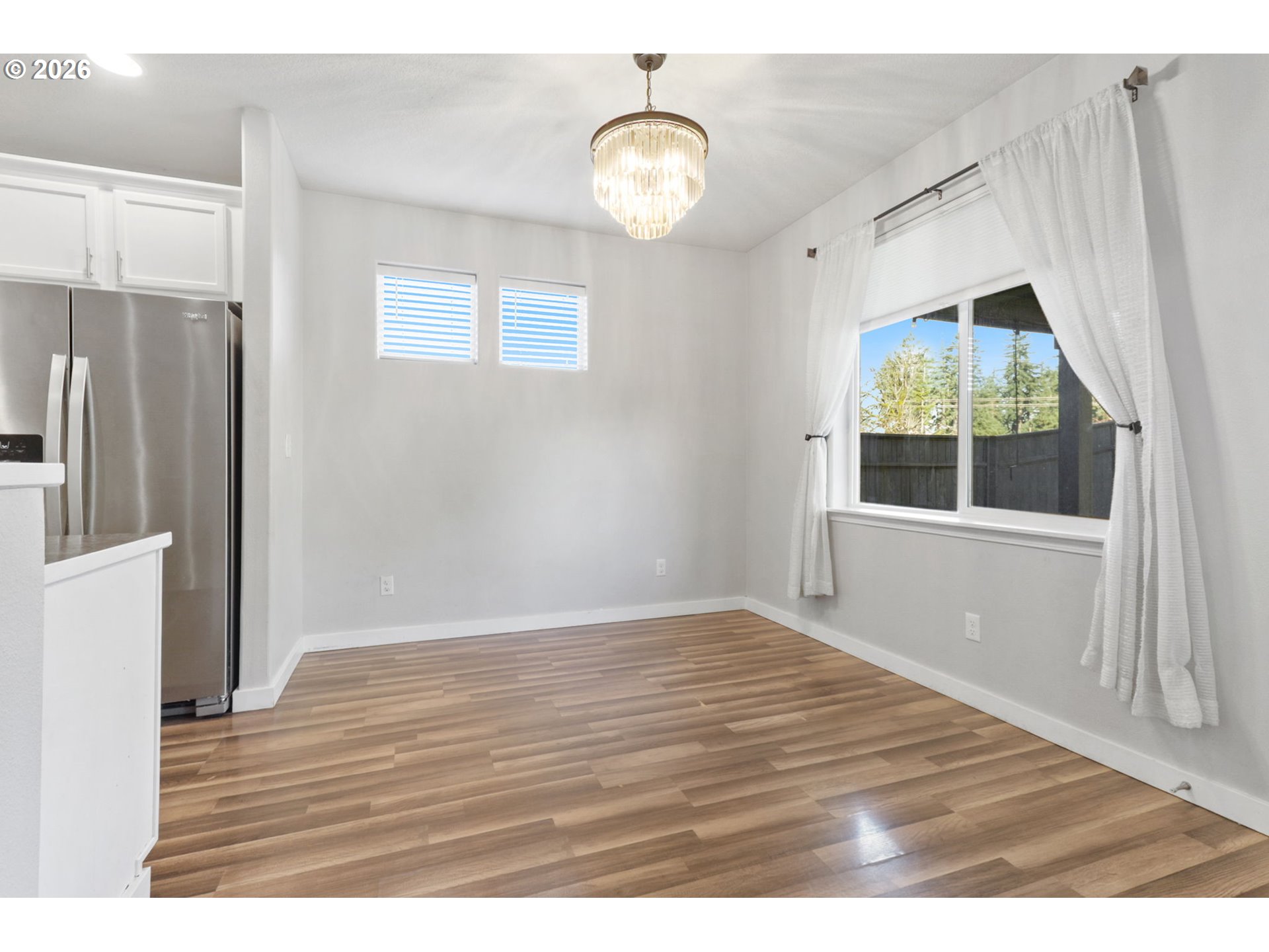 36713 Indian Summer Street Sandy, OR 97055 - Photo 10 of 33 a view of an empty room with wooden floor and windows