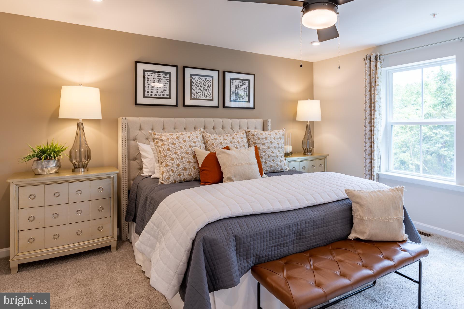 8270 Longford Road Glen Burnie, MD 21061 - Photo 6 of 11 a bed room with a bed and a lamp