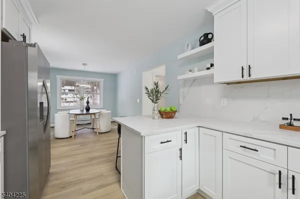 a kitchen with cabinets stainless steel appliances and a sink