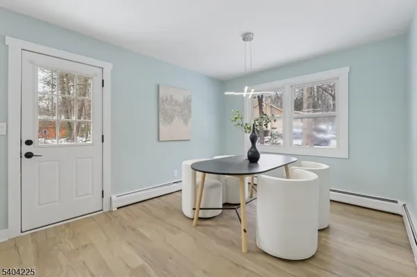 a view of a room with wooden floor and windows