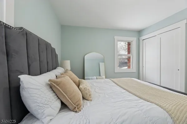 a bedroom with a bed couch and a window