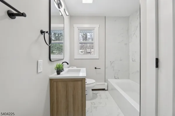 a bath tub sitting next to a white sink