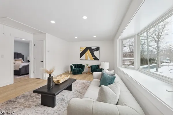 a living room with furniture and a floor to ceiling window