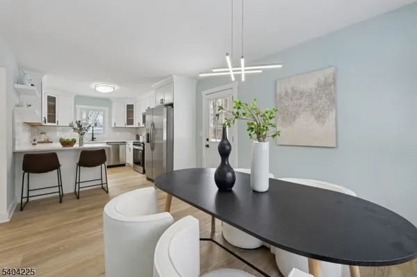 a living room with kitchen island furniture and a chandelier