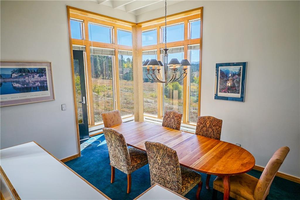 63 Saxifrage Road Keystone, CO 80435 - Photo 14 of 25 a view of a dining room with furniture window and wooden floor