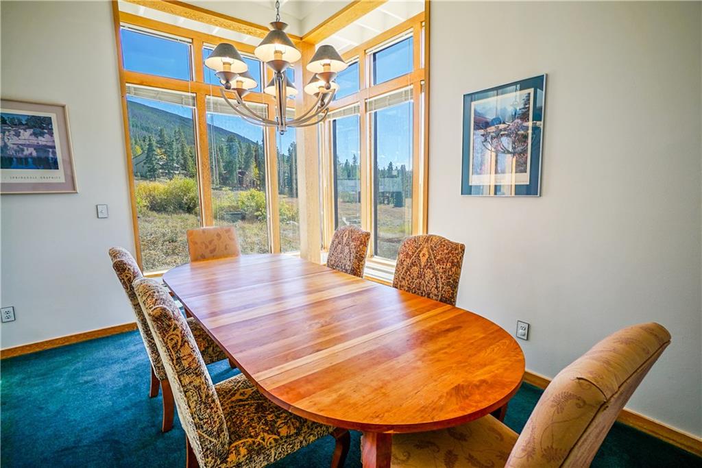 63 Saxifrage Road Keystone, CO 80435 - Photo 15 of 25 a view of a dining room with furniture wooden floor and a chandelier