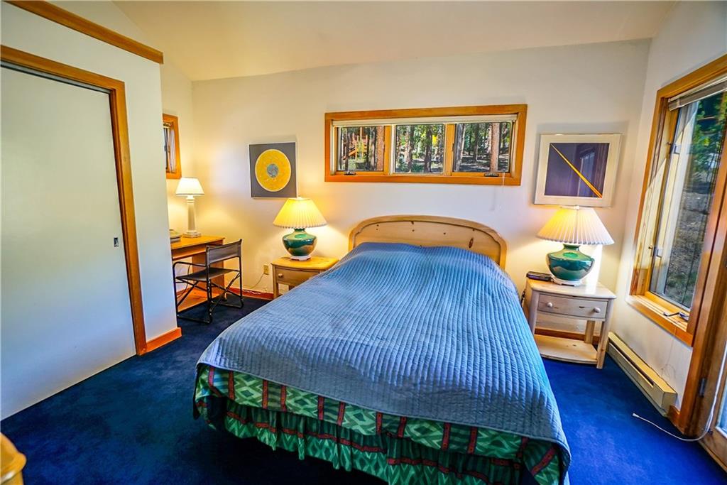 63 Saxifrage Road Keystone, CO 80435 - Photo 21 of 25 a bedroom with a bed and wooden floor