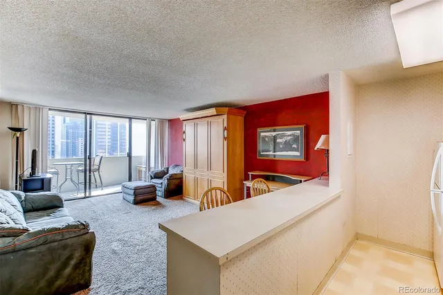 a living room with furniture and large window