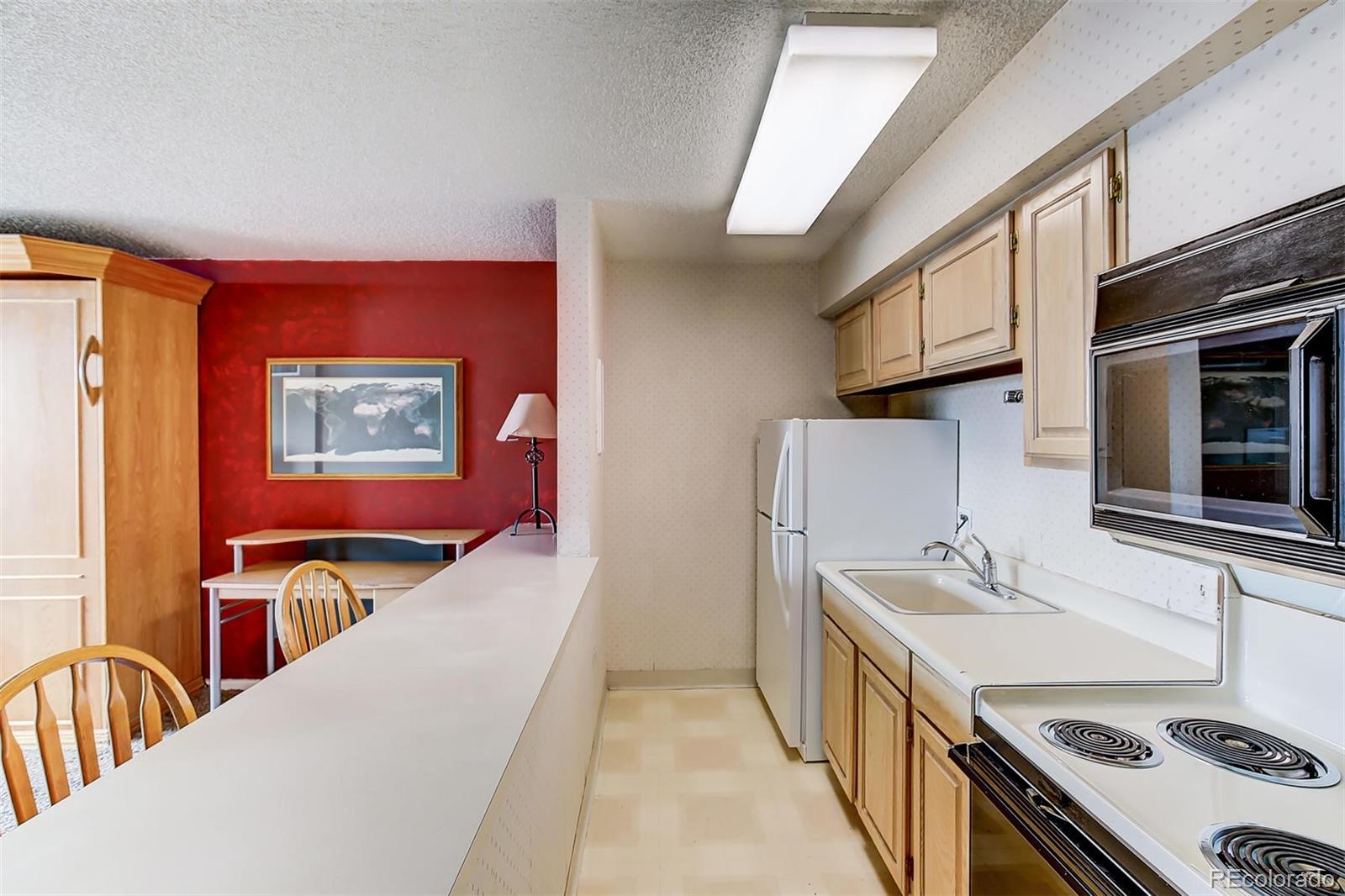 1020 15th Street, Unit 21I Denver, CO 80202 - Photo 3 of 27 a en suite bathroom with a granite countertop double vanity sink a mirror and a bathtub