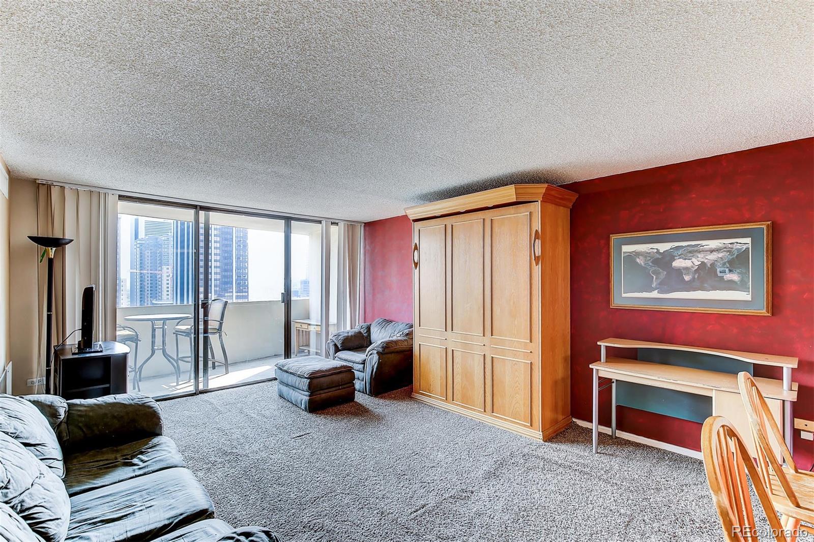 1020 15th Street, Unit 21I Denver, CO 80202 - Photo 5 of 27 a living room with furniture a large window and a flat screen tv