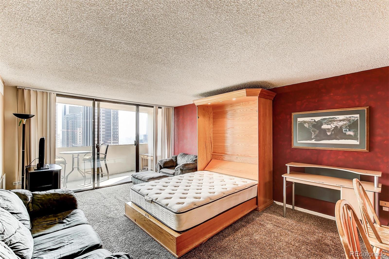 1020 15th Street, Unit 21I Denver, CO 80202 - Photo 6 of 27 a bedroom with a bed and glass window