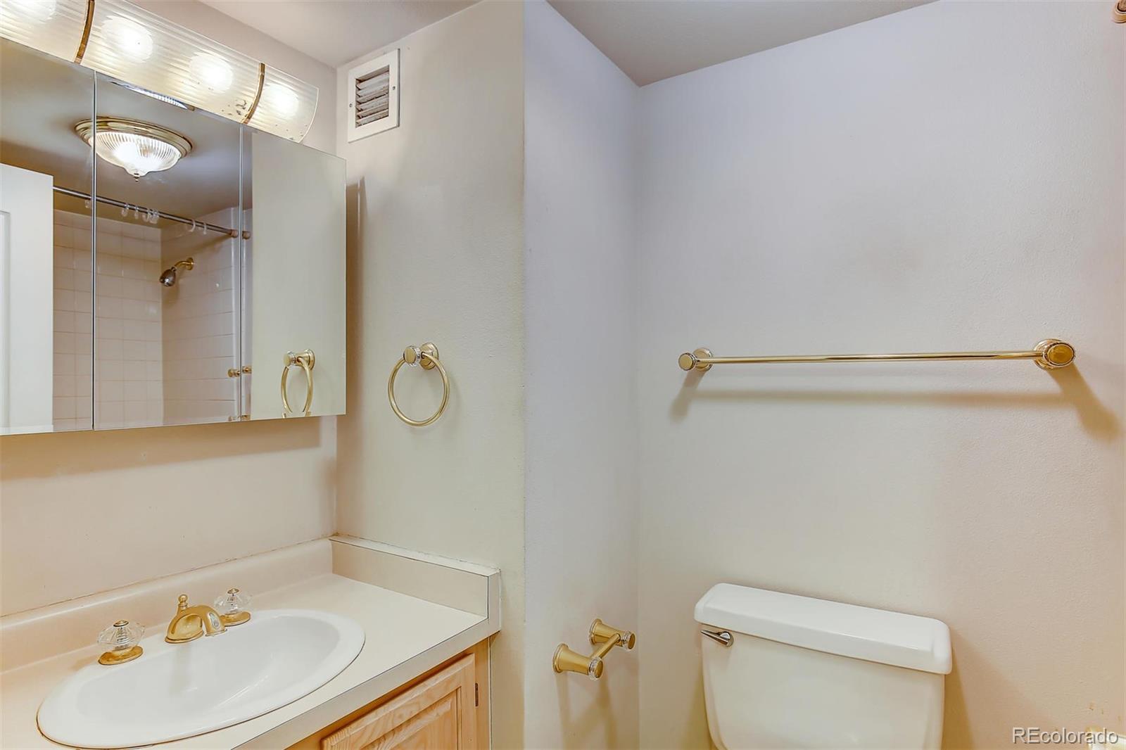 1020 15th Street, Unit 21I Denver, CO 80202 - Photo 9 of 27 a bathroom with a sink vanity and toilet