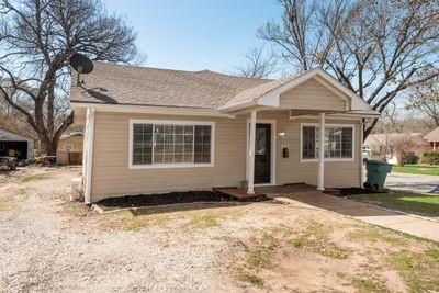 930 Freeman Street Sherman, TX 75092 - Photo 2 of 18 Single-story residence featuring light-colored siding and a covered front porch with white columns