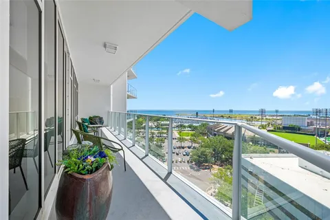 a view of a balcony with lake view and a potted plant
