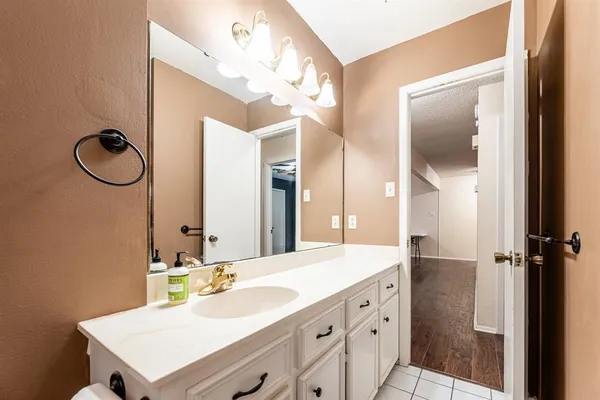 a bathroom with a sink vanity and a mirror