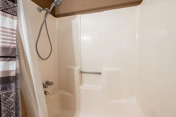 a bathroom with a glass shower door