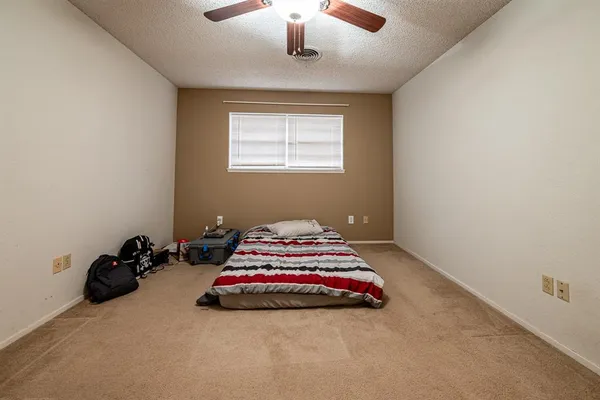 a bed room with a bed and a window