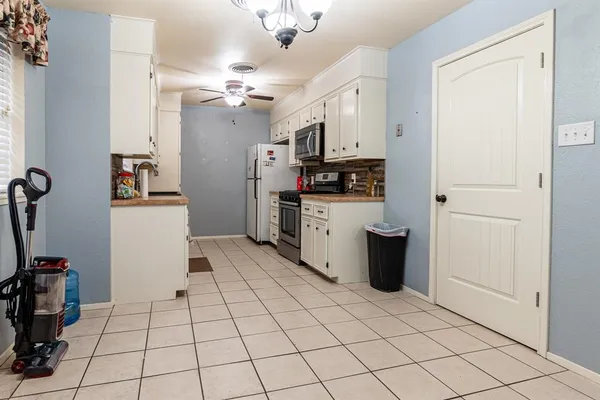 a kitchen with stainless steel appliances a refrigerator sink and cabinets
