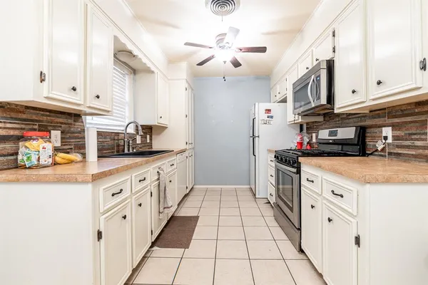 a kitchen with stainless steel appliances granite countertop a sink and cabinets