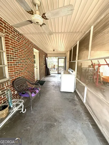 a view of a patio with table and chairs and potted plants