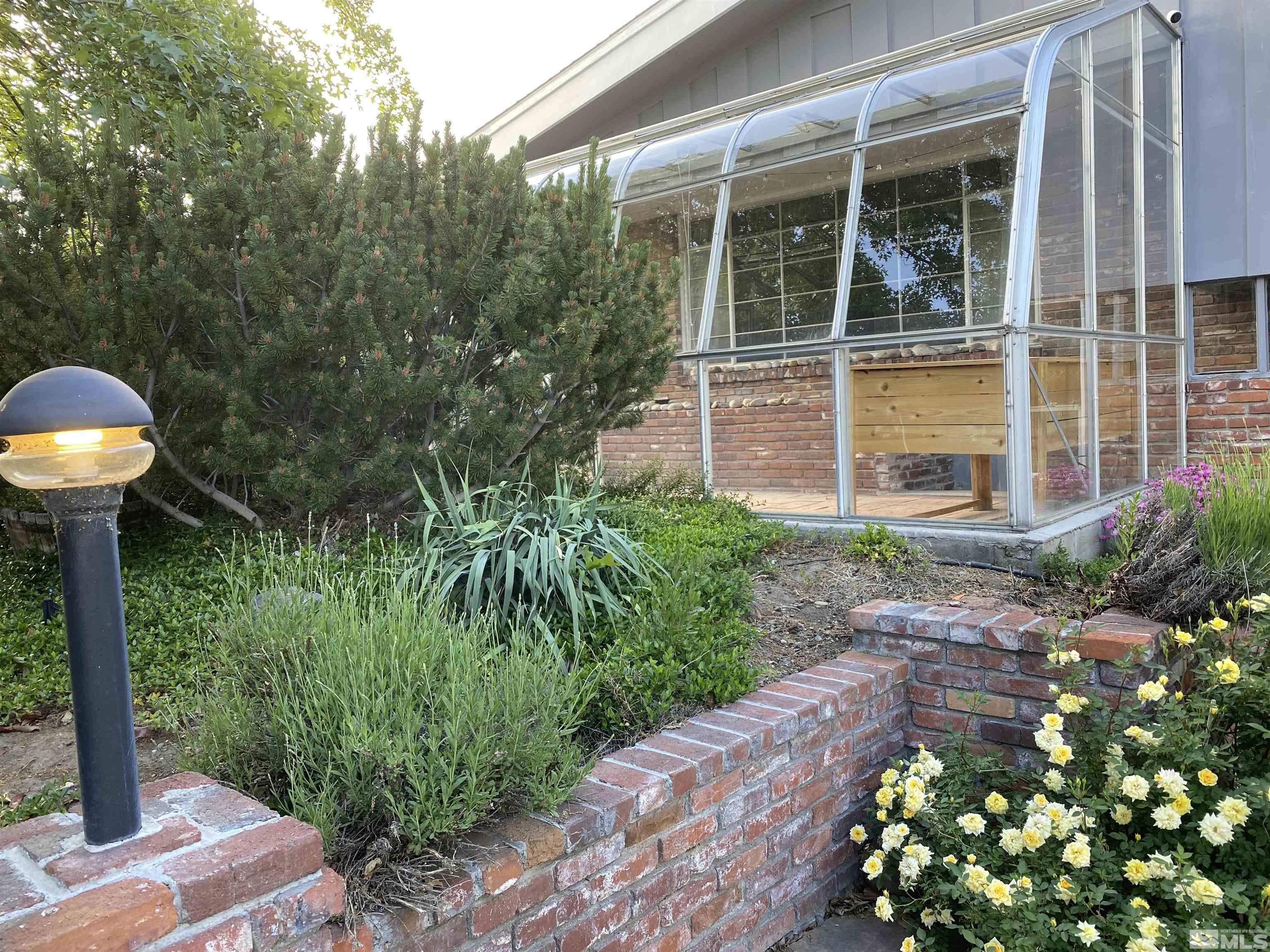 945 West 12th Street Reno, NV 89503 - Photo 2 of 29 a front view of a house with a garden and plants