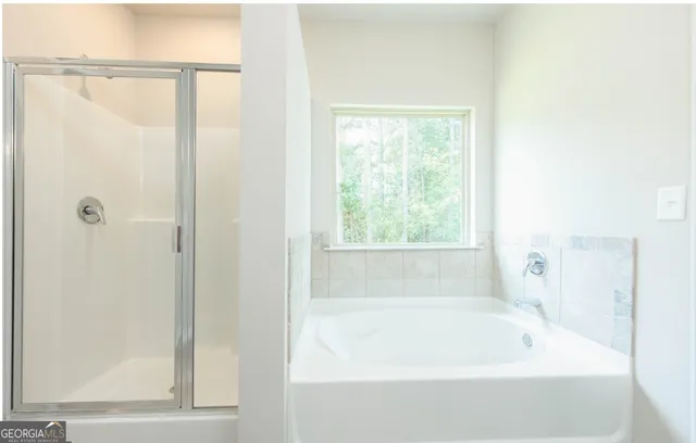 a bathroom with bathtub and window