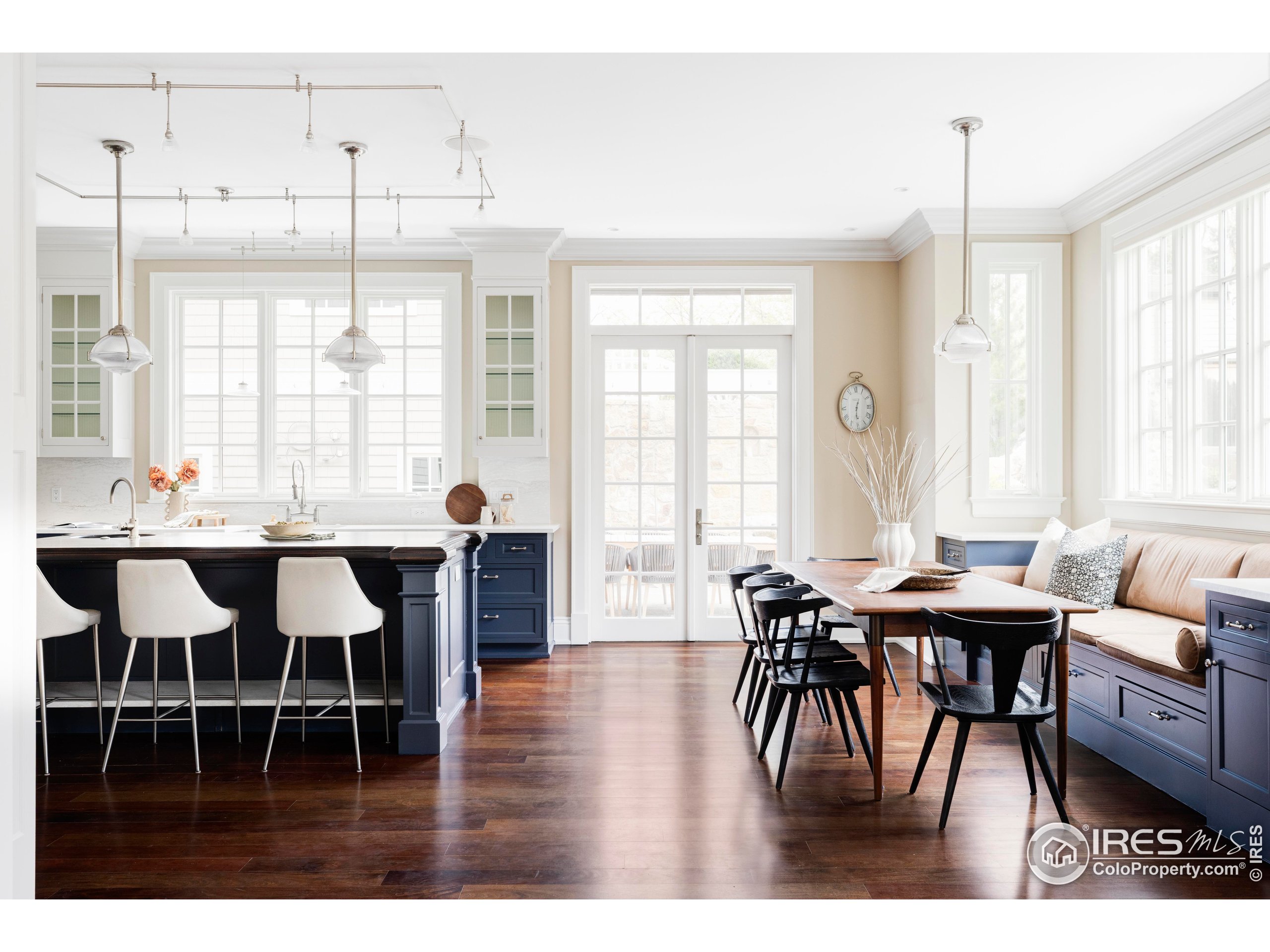 a dining room with furniture a chandelier and wooden floor