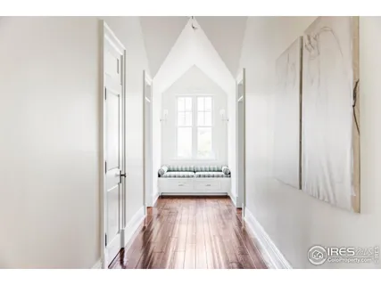 a view of a room with wooden floor and windows