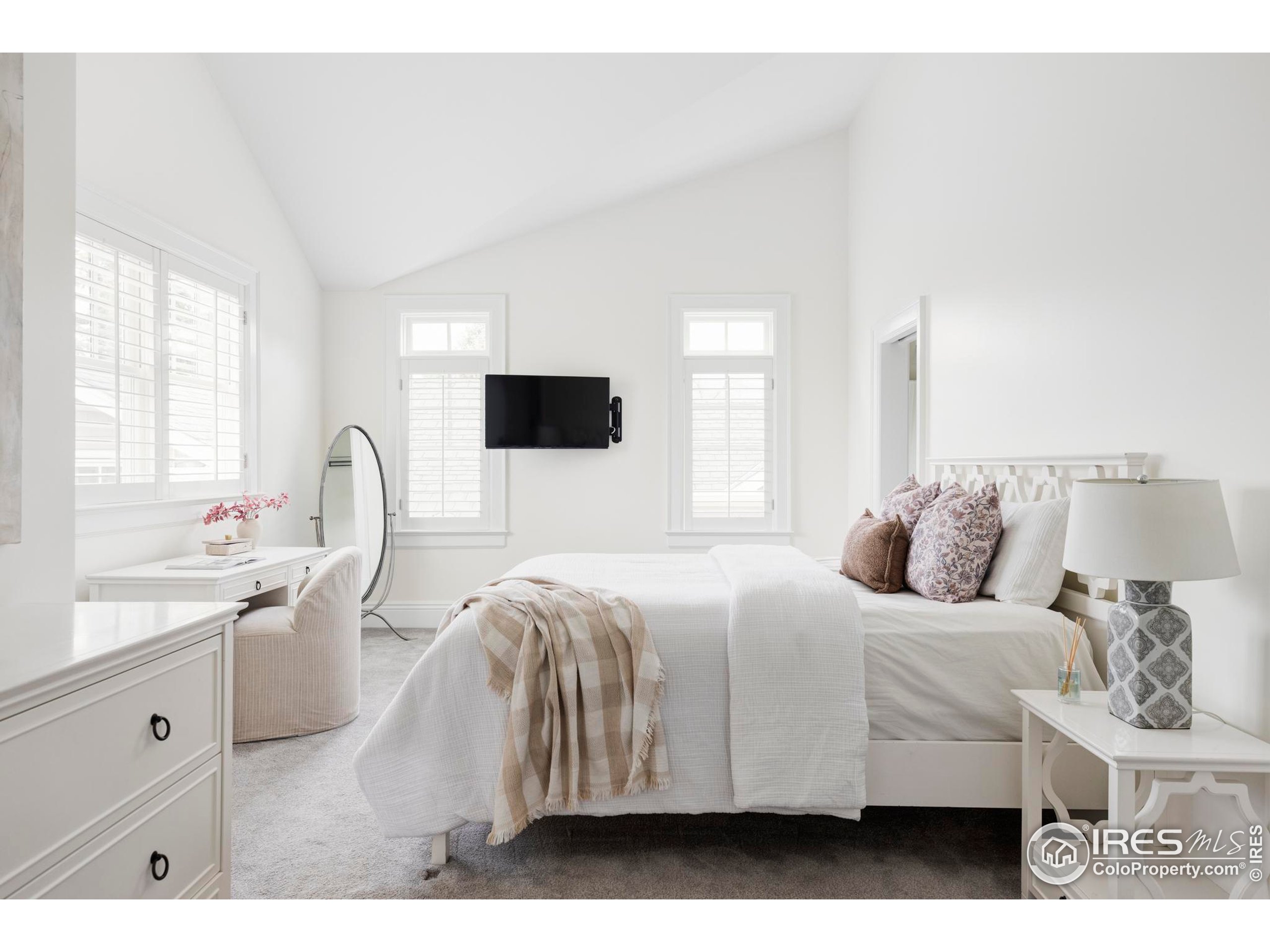 3189 5th Street Boulder, CO 80304 - Photo 21 of 37 a bedroom with a bed and a flat screen tv