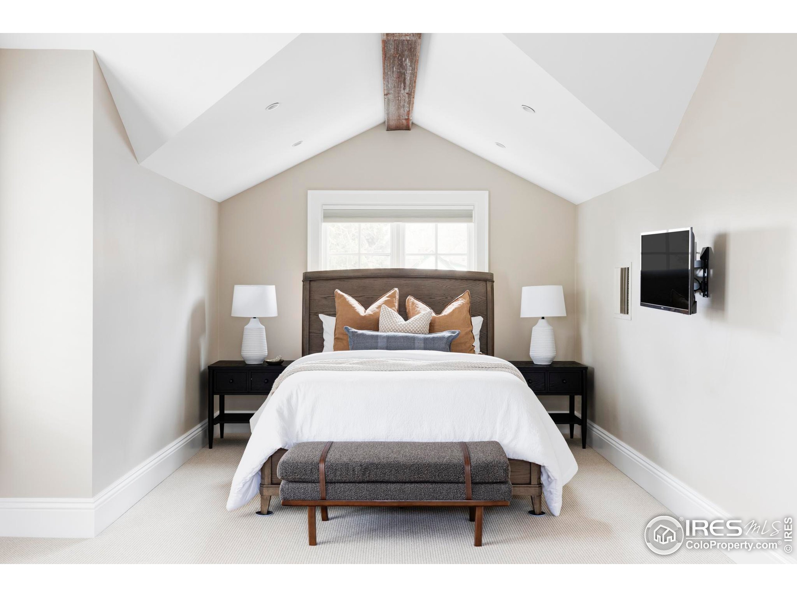 3189 5th Street Boulder, CO 80304 - Photo 30 of 37 a bedroom with a bed a tv and wooden floor