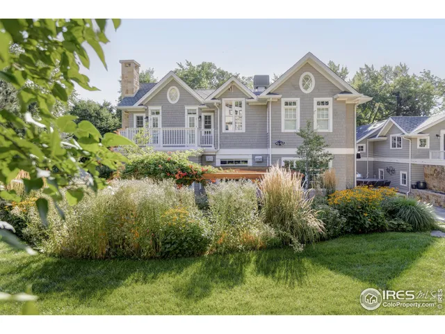 a view of a big house with a big yard and potted plants