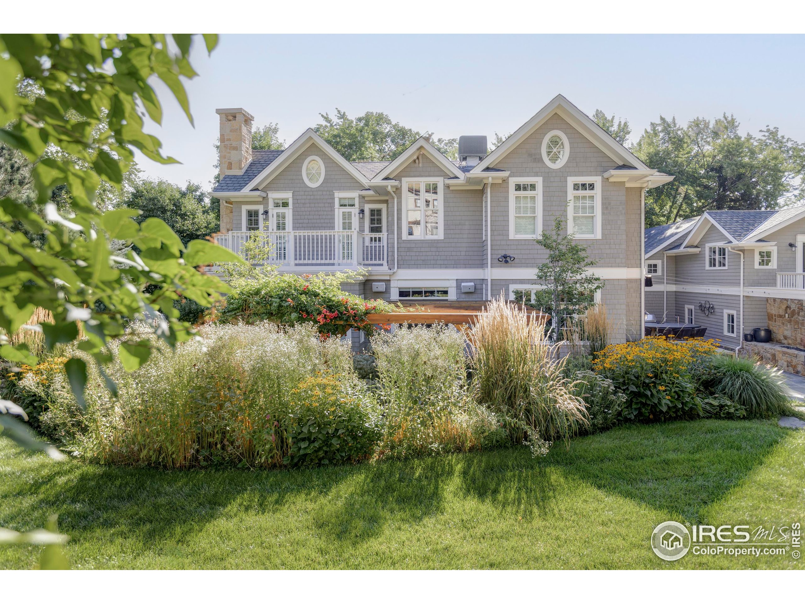 3189 5th Street Boulder, CO 80304 - Photo 3 of 37 a view of a big house with a big yard and potted plants