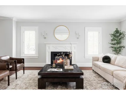 a living room with furniture a fireplace and window