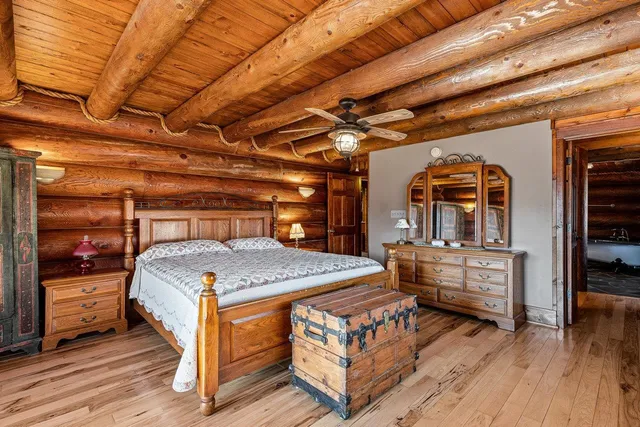 a bedroom with furniture window and wooden floor