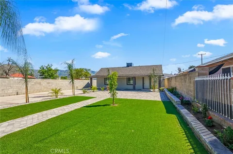 a view of an house with backyard and porch