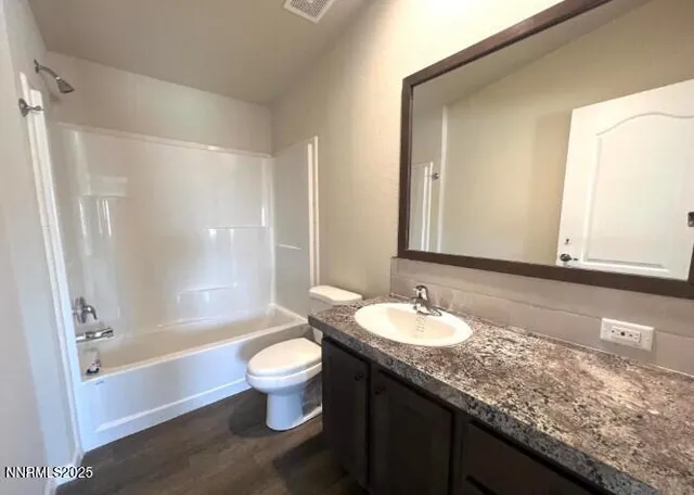 a bathroom with a granite countertop tub sink and mirror