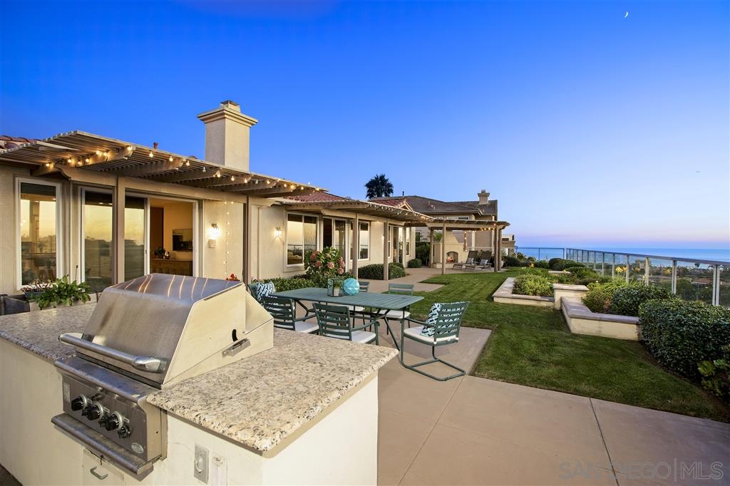 a view of a house with backyard sitting area and garden