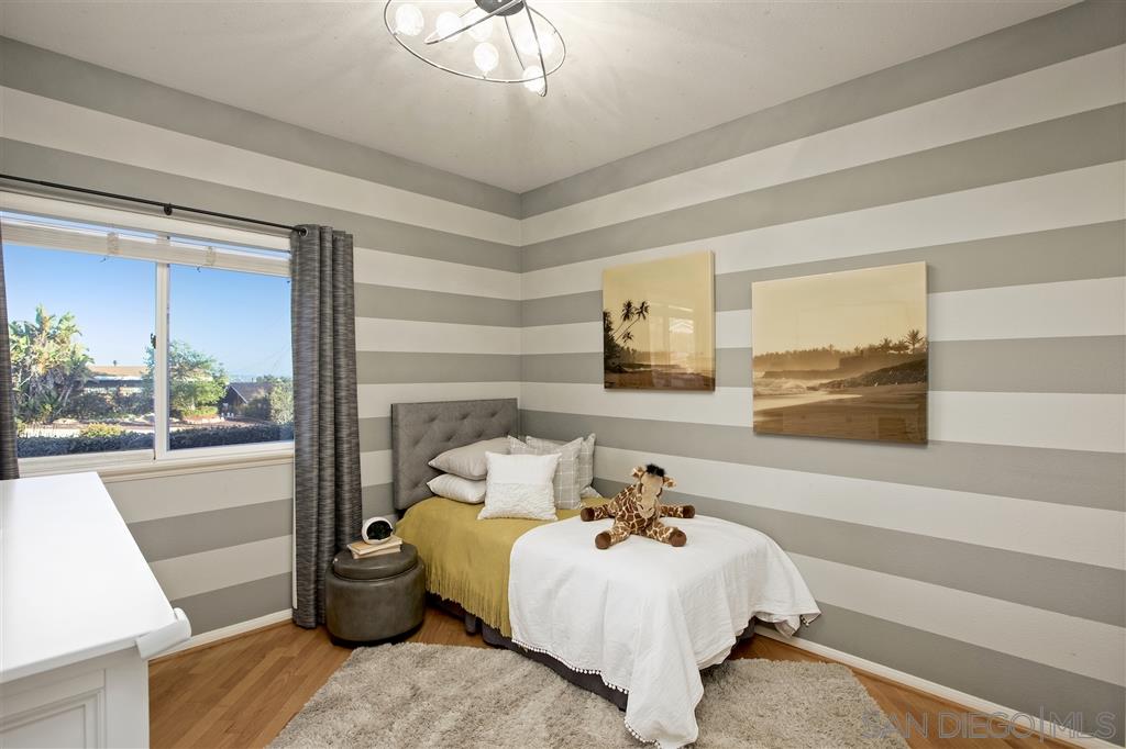 5466 Soledad Road La Jolla, CA 92037 - Photo 11 of 18 a bed room with a bed and a painting on the wall