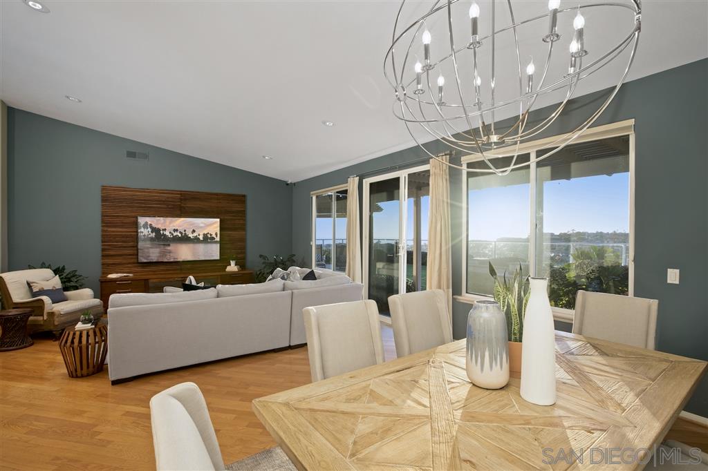 5466 Soledad Road La Jolla, CA 92037 - Photo 6 of 18 a living room with furniture a chandelier and a flat screen tv