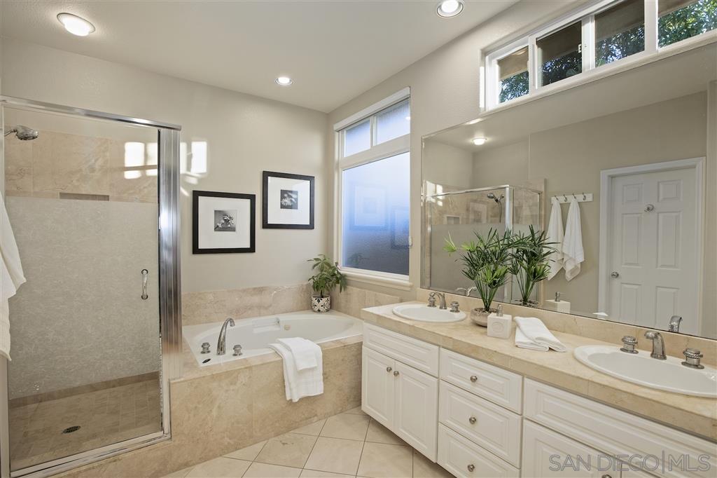 5466 Soledad Road La Jolla, CA 92037 - Photo 9 of 18 a spacious bathroom with a double vanity sink mirror and bathtub