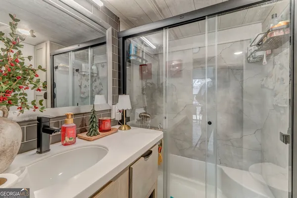 a kitchen with stainless steel appliances granite countertop a refrigerator a stove a sink dishwasher a dining table and chairs with wooden floor