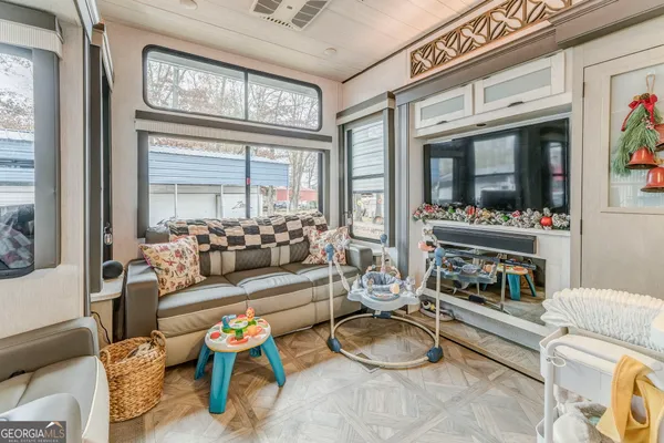 a view of a porch with wooden floor and furniture