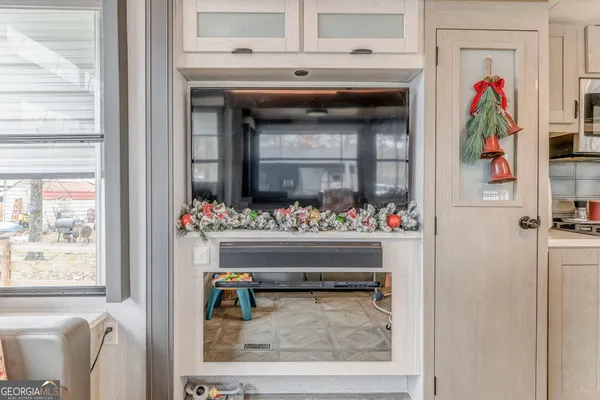 a view of a room with lots of furniture and wooden floor