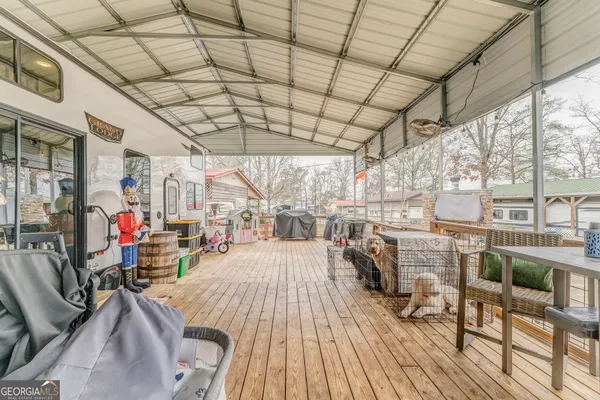a view of a house with backyard porch and sitting area