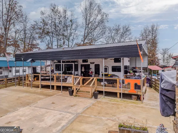 an outdoor seating area with furniture and barbeque oven