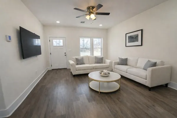 a living room with furniture and a flat screen tv