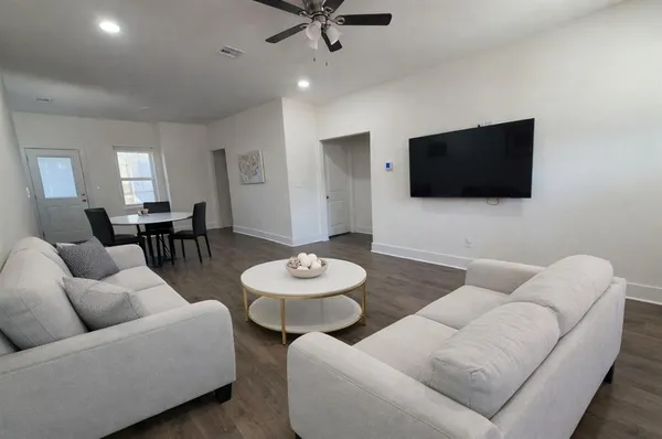 a living room with furniture and a flat screen tv