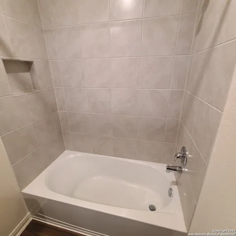 an empty room with chandelier fan