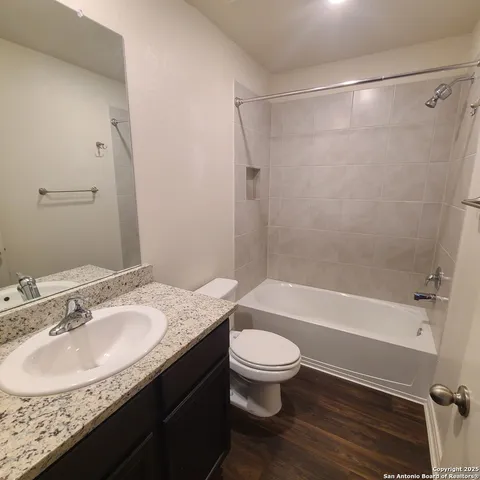a bathroom with a glass shower door and sink