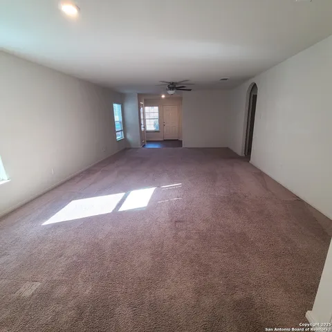 a view of a house with a wooden fence